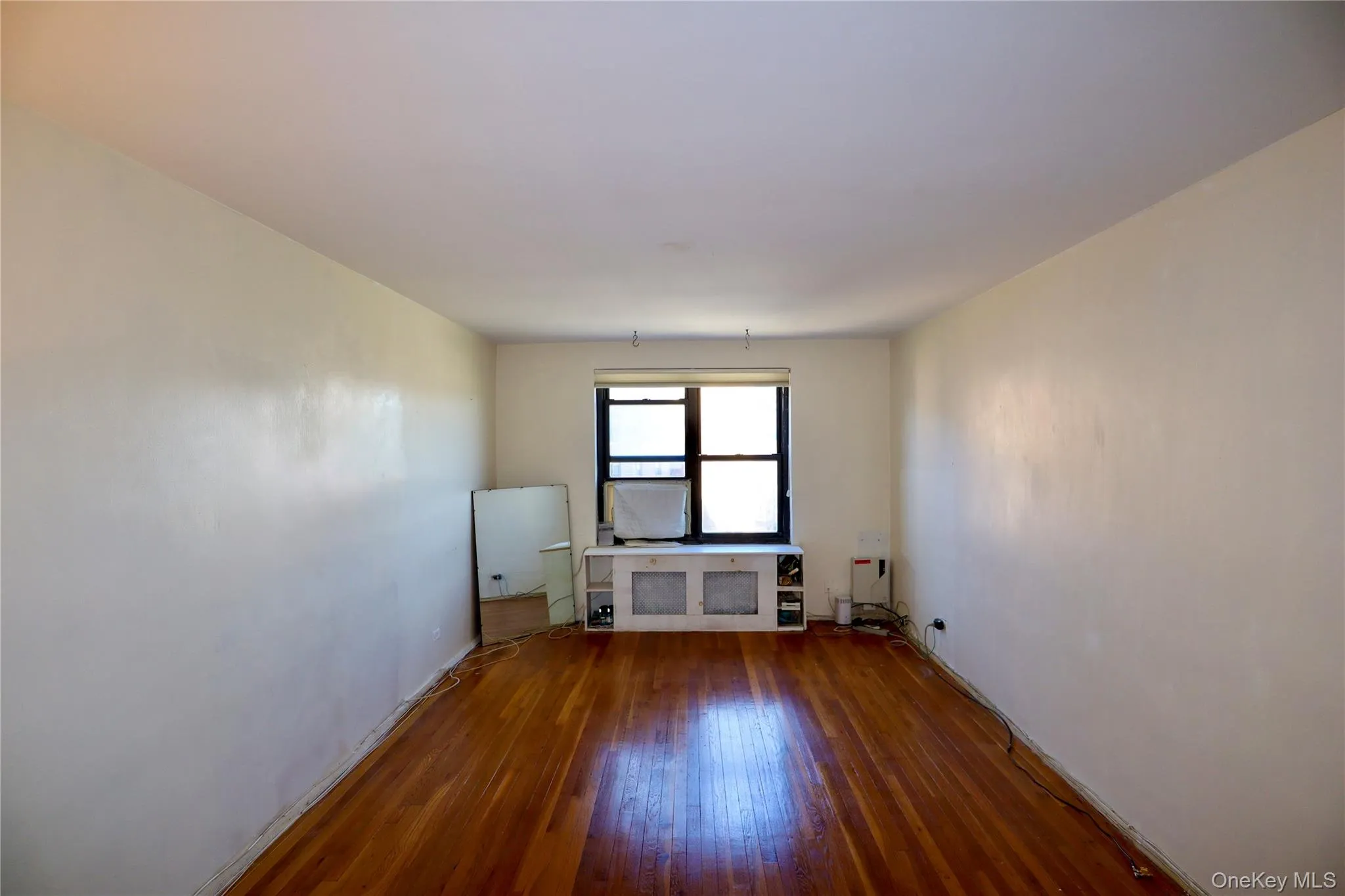 Spare room with wood finished floors and baseboards Spare room with wood finished floors and baseboards