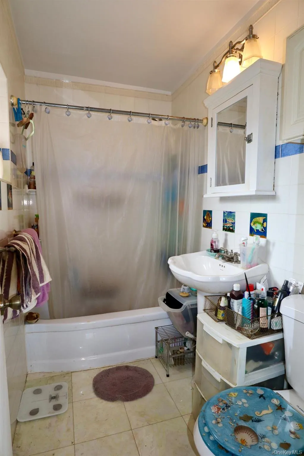 Bathroom featuring ornamental molding, shower / bath combo, and tile patterned flooring Bathroom featuring ornamental molding, shower / bath combo, and tile patterned flooring