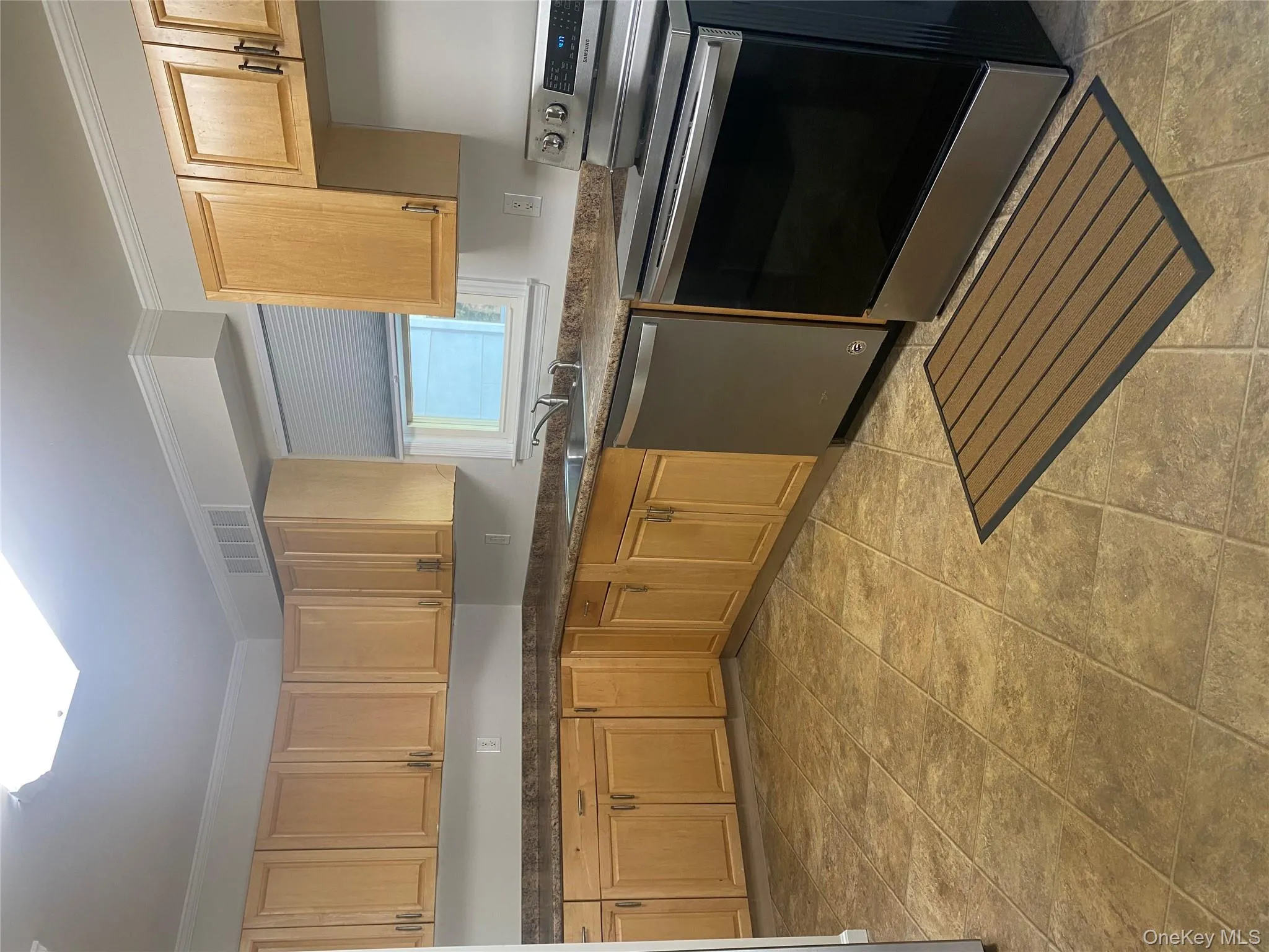 Eat in Kitchen featuring dishwasher, range, ornamental molding, and light brown cabinets Eat in Kitchen featuring dishwasher, range, ornamental molding, and light brown cabinets