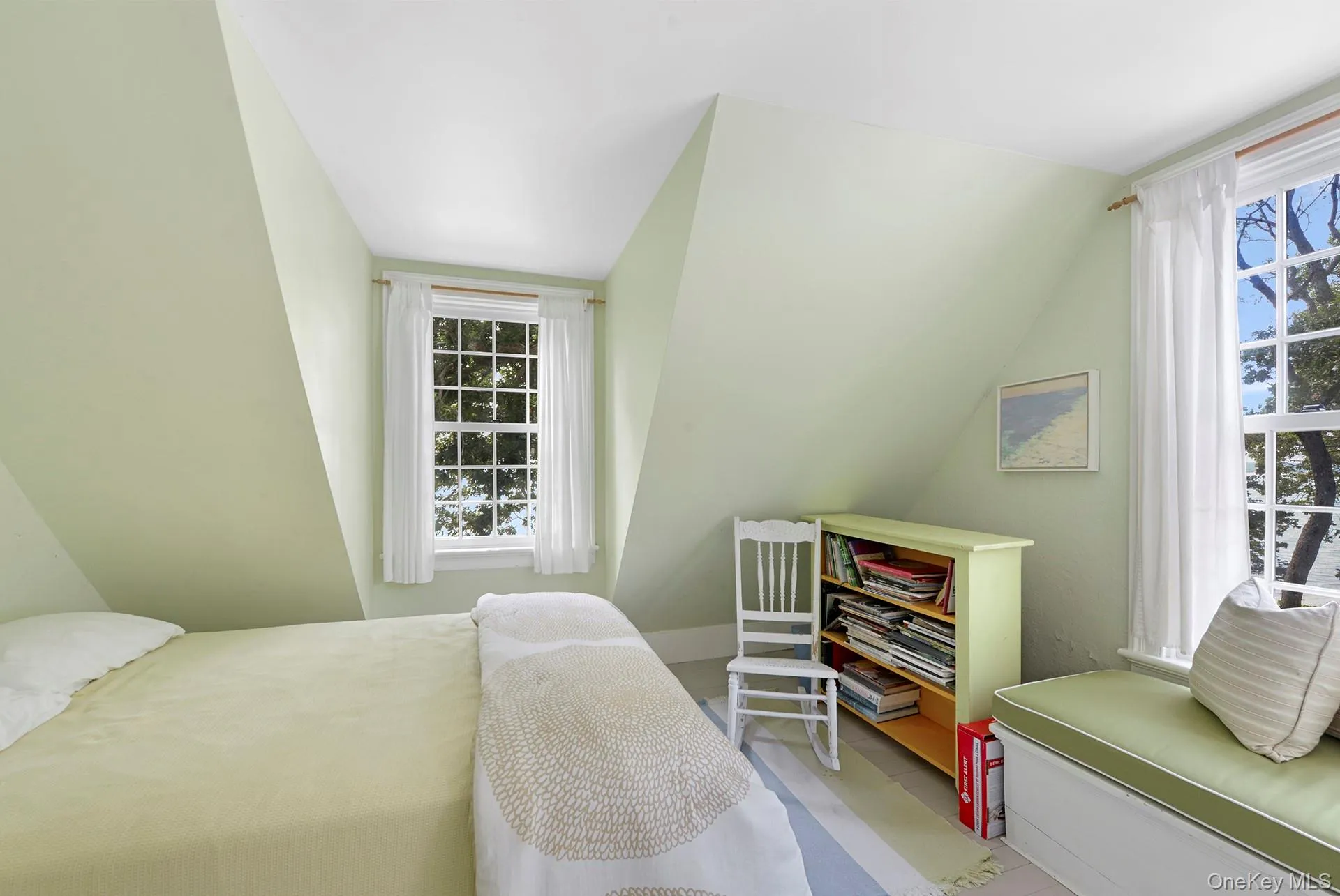 Bedroom featuring multiple windows and vaulted ceiling Bedroom featuring multiple windows and vaulted ceiling