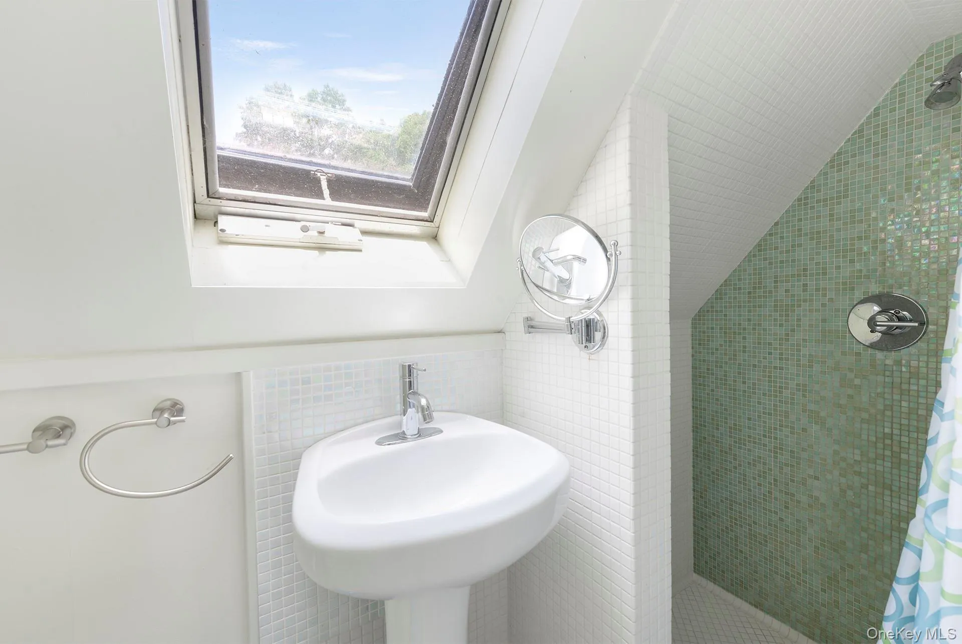 Full bathroom with tile walls, a tile shower, and a skylight Full bathroom with tile walls, a tile shower, and a skylight