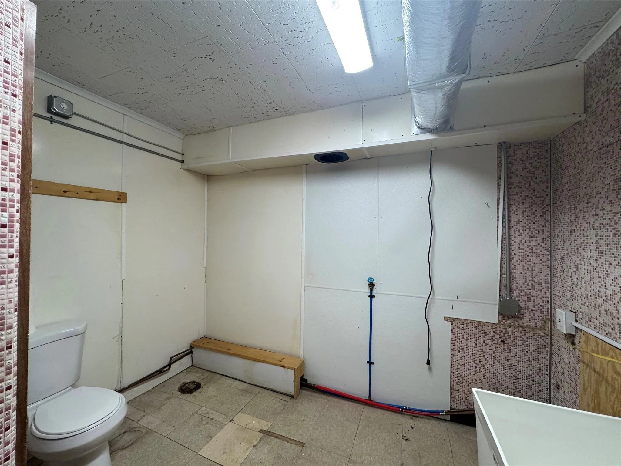 Finished basement featuring light floors Finished basement featuring light floors