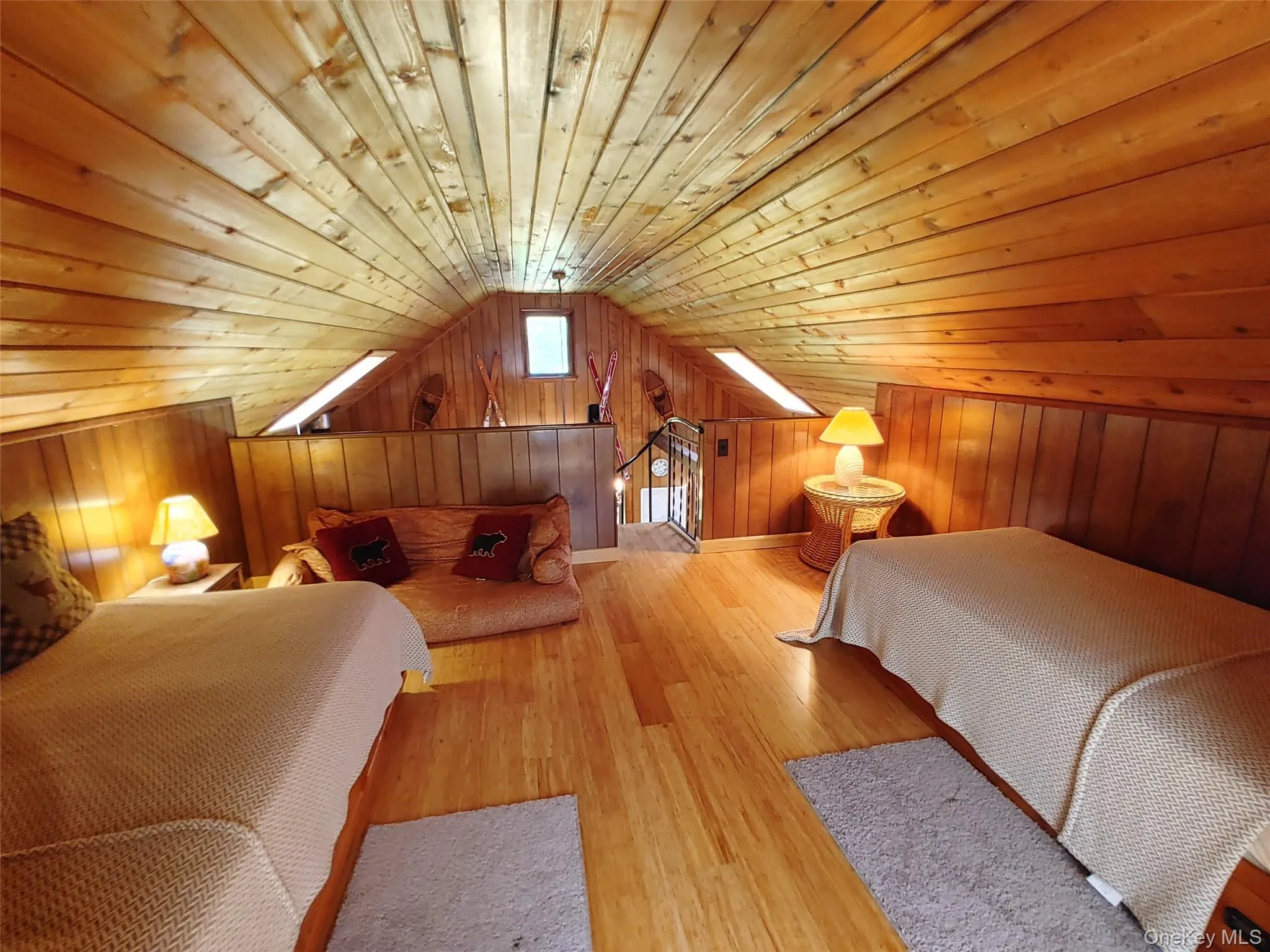 Bedroom with wood walls, wooden ceiling, bamboo flooring, and vaulted ceiling Bedroom with wood walls, wooden ceiling, bamboo flooring, and vaulted ceiling
