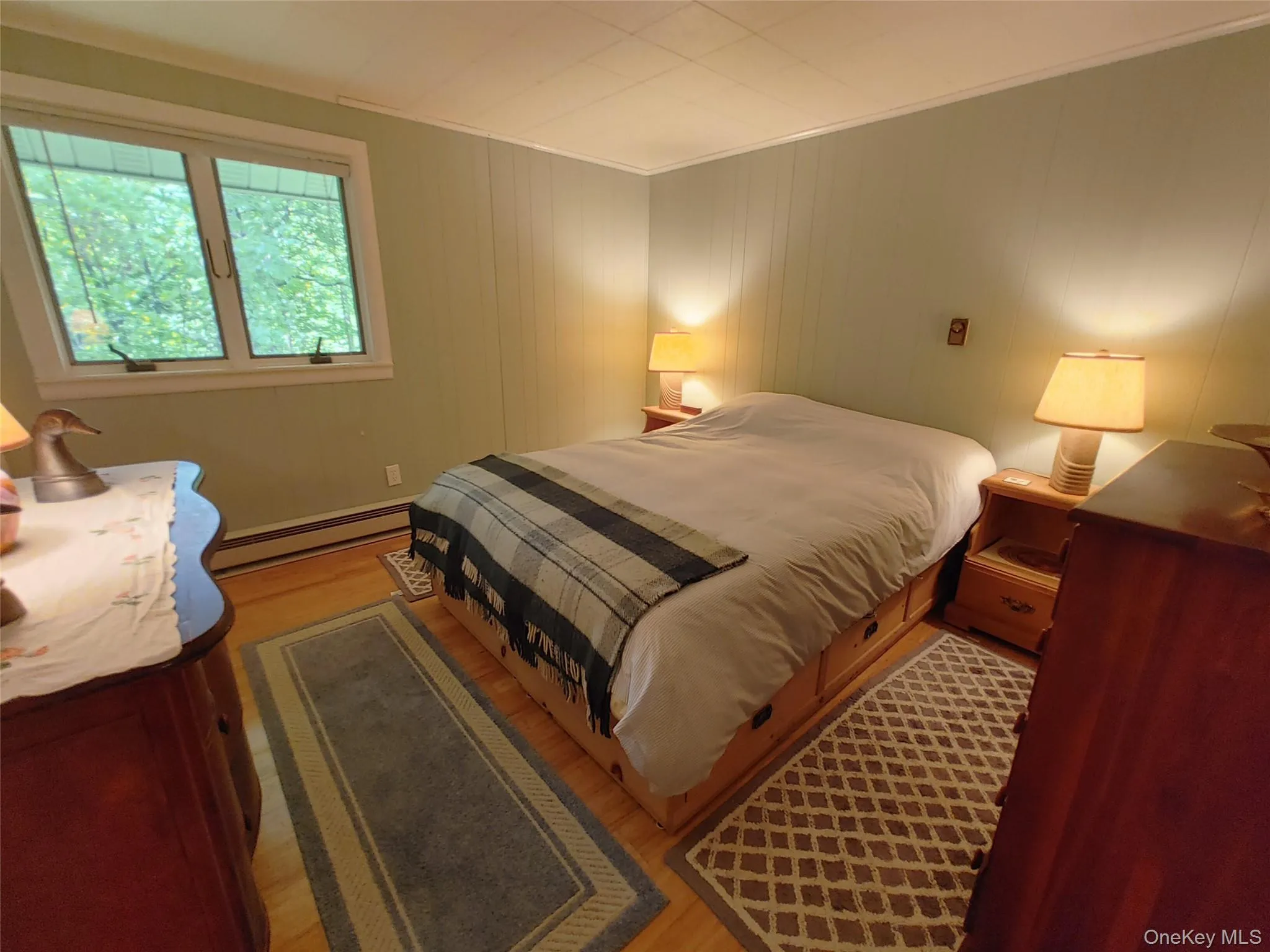 Bedroom with baseboard heating and bamboo plank wood floors Bedroom with baseboard heating and bamboo plank wood floors