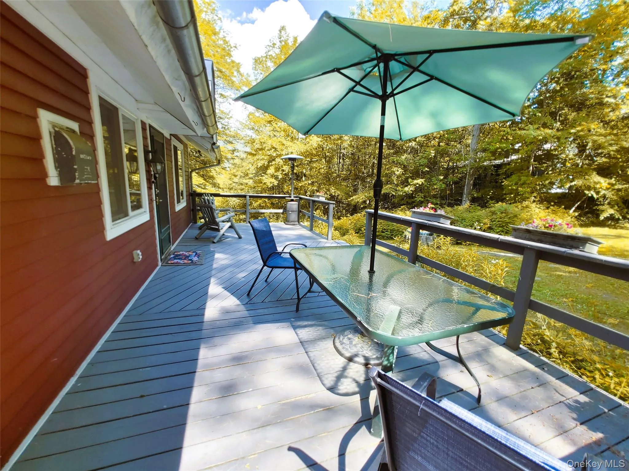 Wooden terrace featuring outdoor dining & lounging areas Wooden terrace featuring outdoor dining & lounging areas
