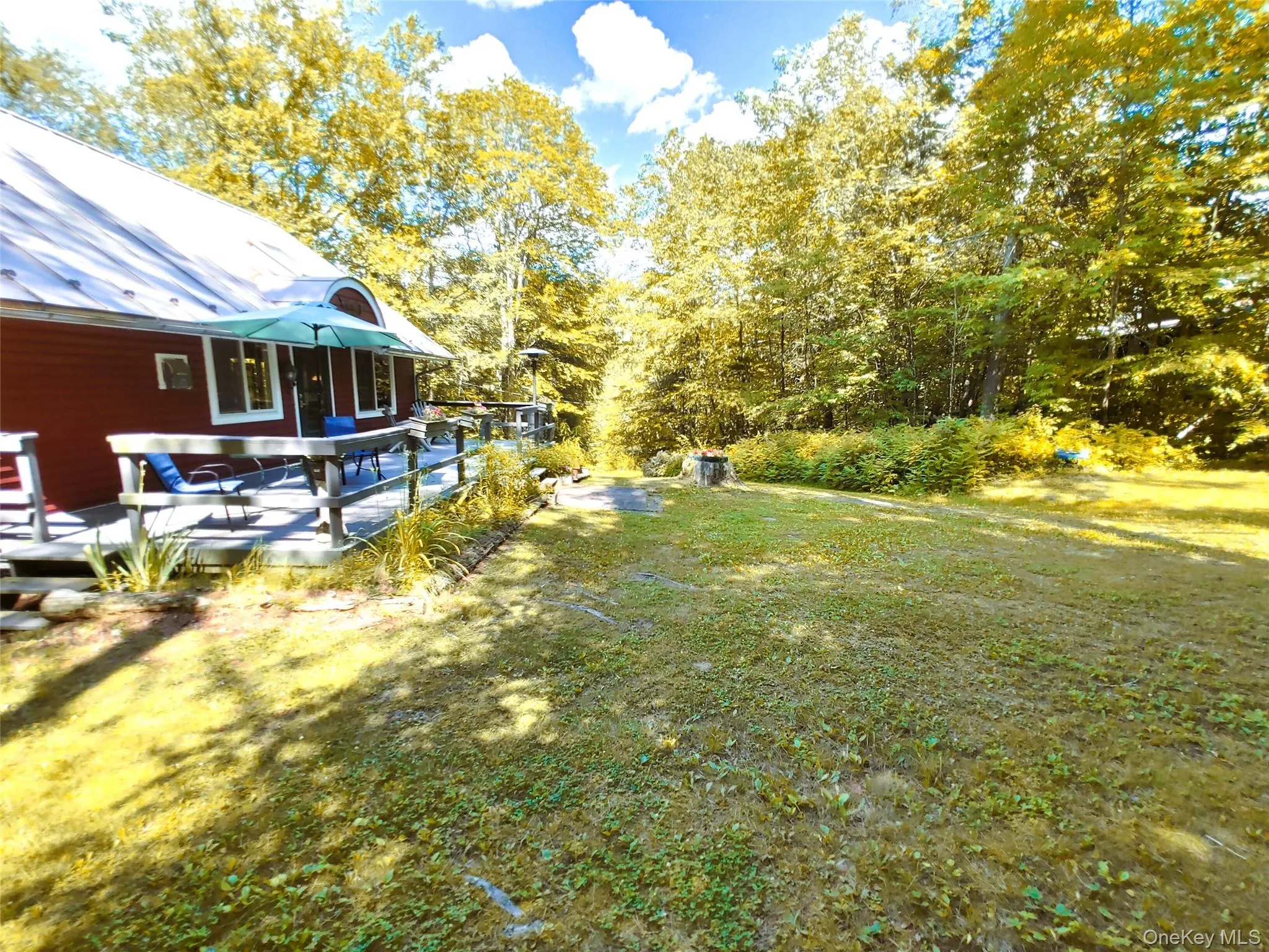 View of grassy yard featuring a deck View of grassy yard featuring a deck