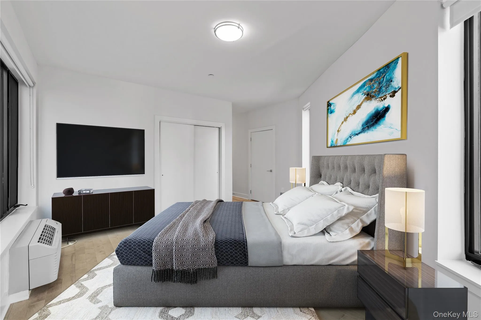Bedroom featuring wood finished floors and a closet Bedroom featuring wood finished floors and a closet
