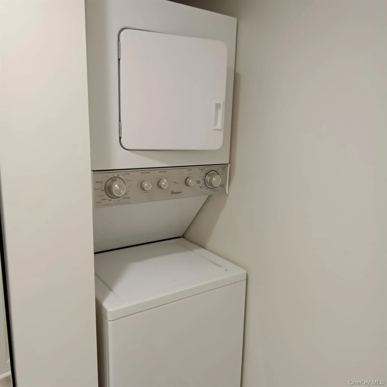 Laundry room featuring stacked washer and clothes dryer Laundry room featuring stacked washer and clothes dryer