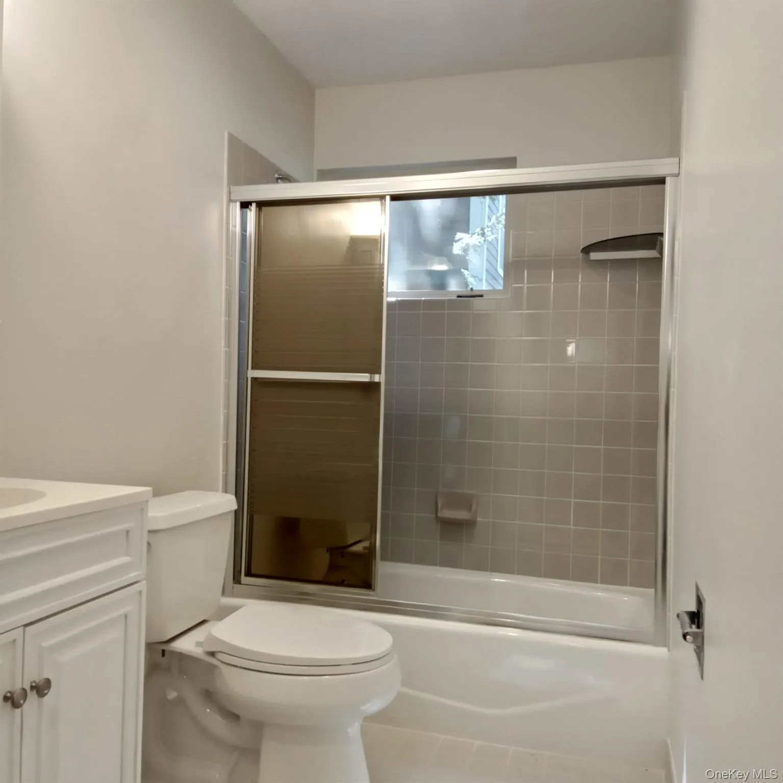 Bathroom featuring combined bath / shower with glass door and vanity Bathroom featuring combined bath / shower with glass door and vanity