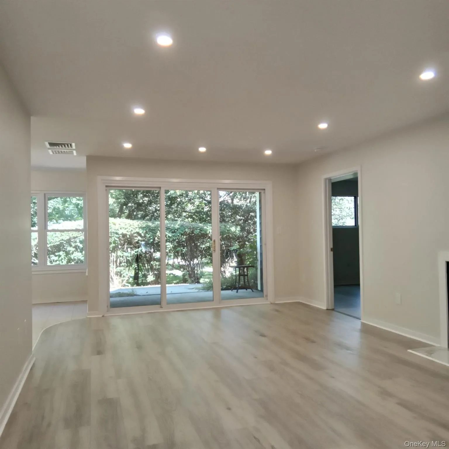 Family room with recessed lighting and light wood-style floors Family room with recessed lighting and light wood-style floors