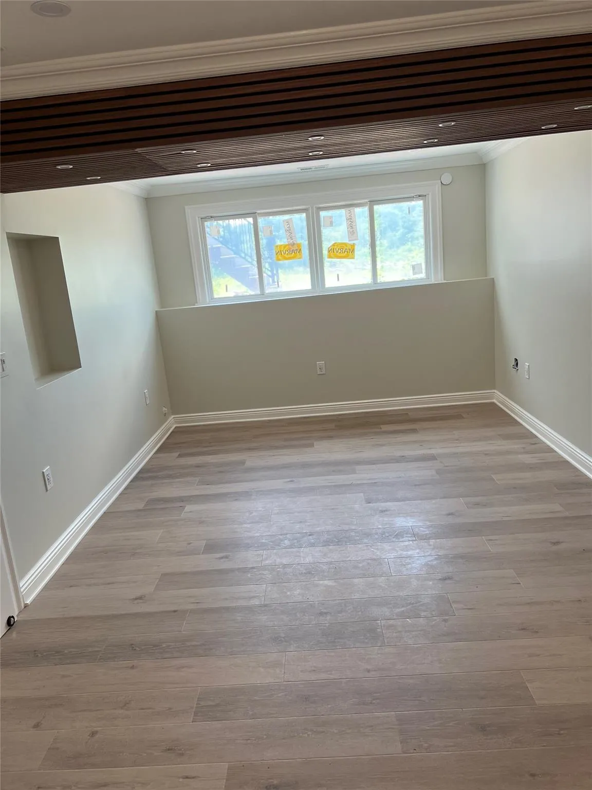 Unfurnished room with crown molding, healthy amount of natural light, and light wood-style floors Unfurnished room with crown molding, healthy amount of natural light, and light wood-style floors