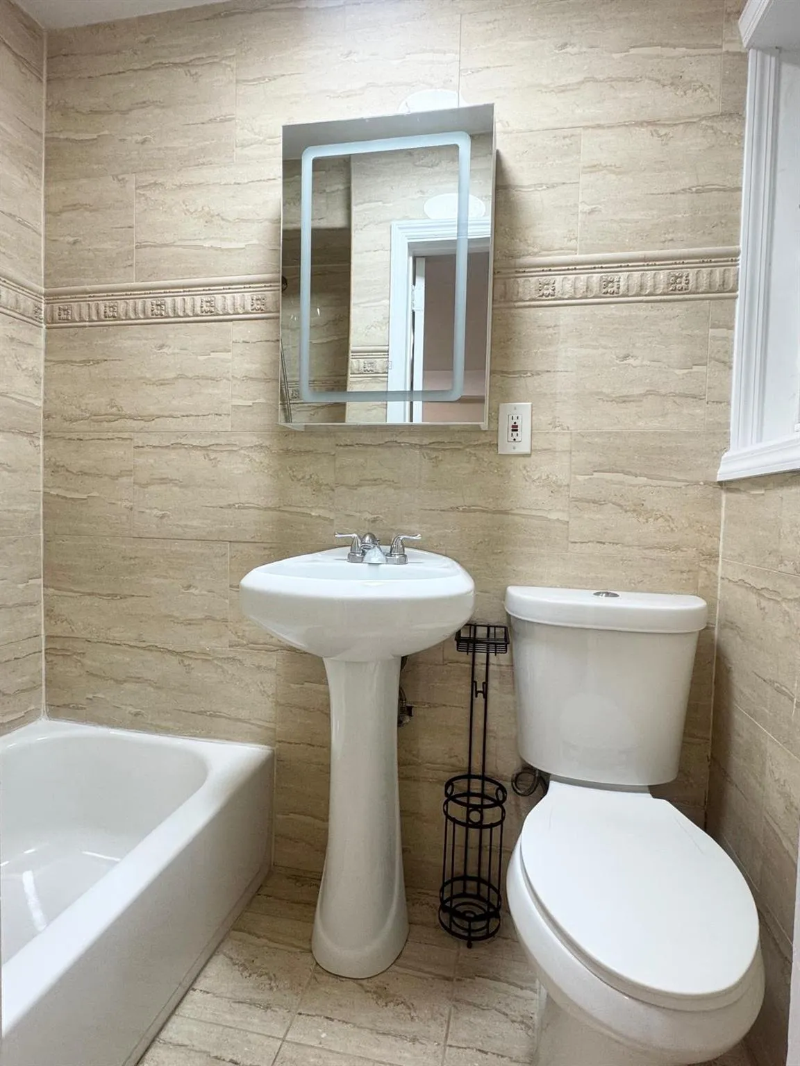 Full bathroom featuring a bath and tile patterned floors Full bathroom featuring a bath and tile patterned floors