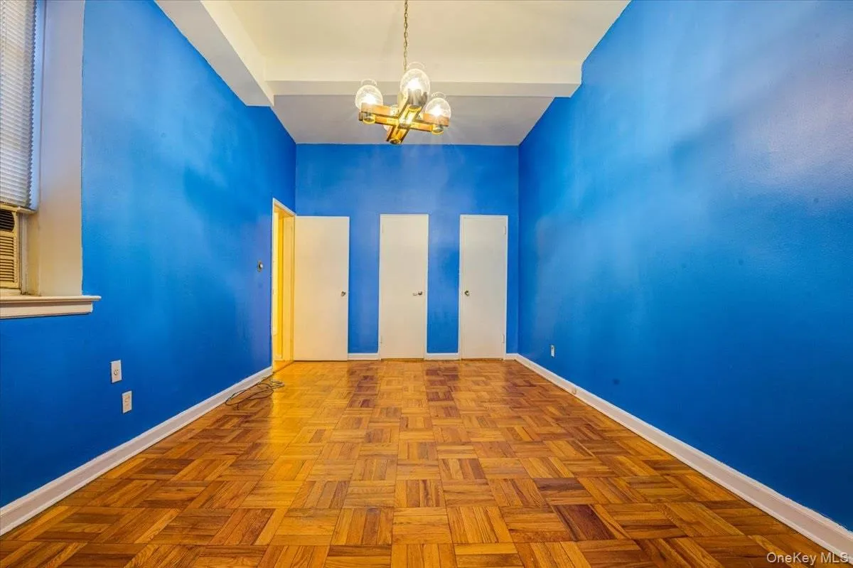 Empty room featuring a chandelier and baseboards Empty room featuring a chandelier and baseboards
