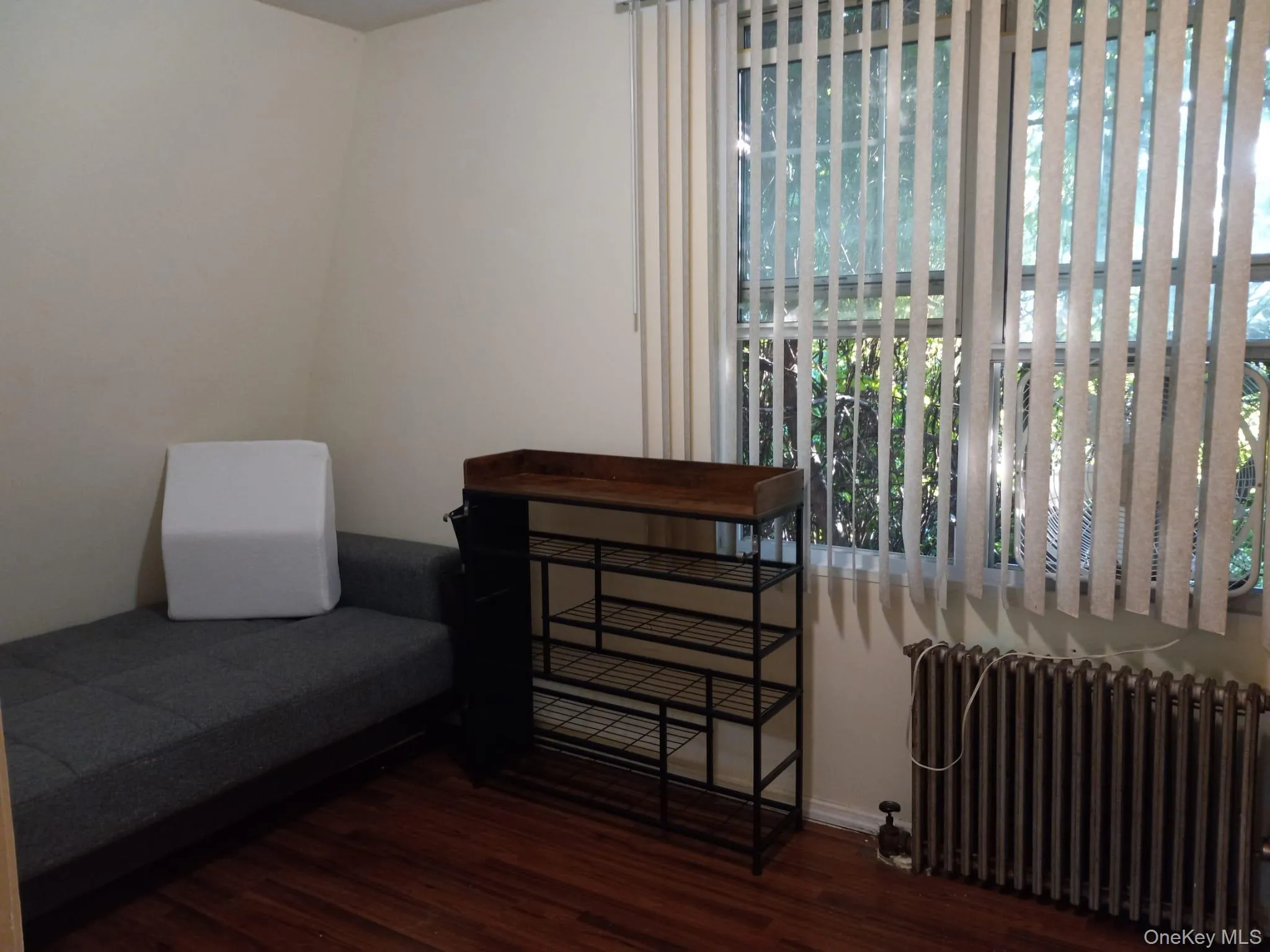 Sitting room with radiator and wood finished floors Sitting room with radiator and wood finished floors