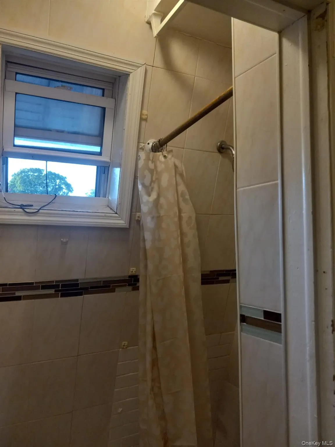 Bathroom featuring a tile shower Bathroom featuring a tile shower