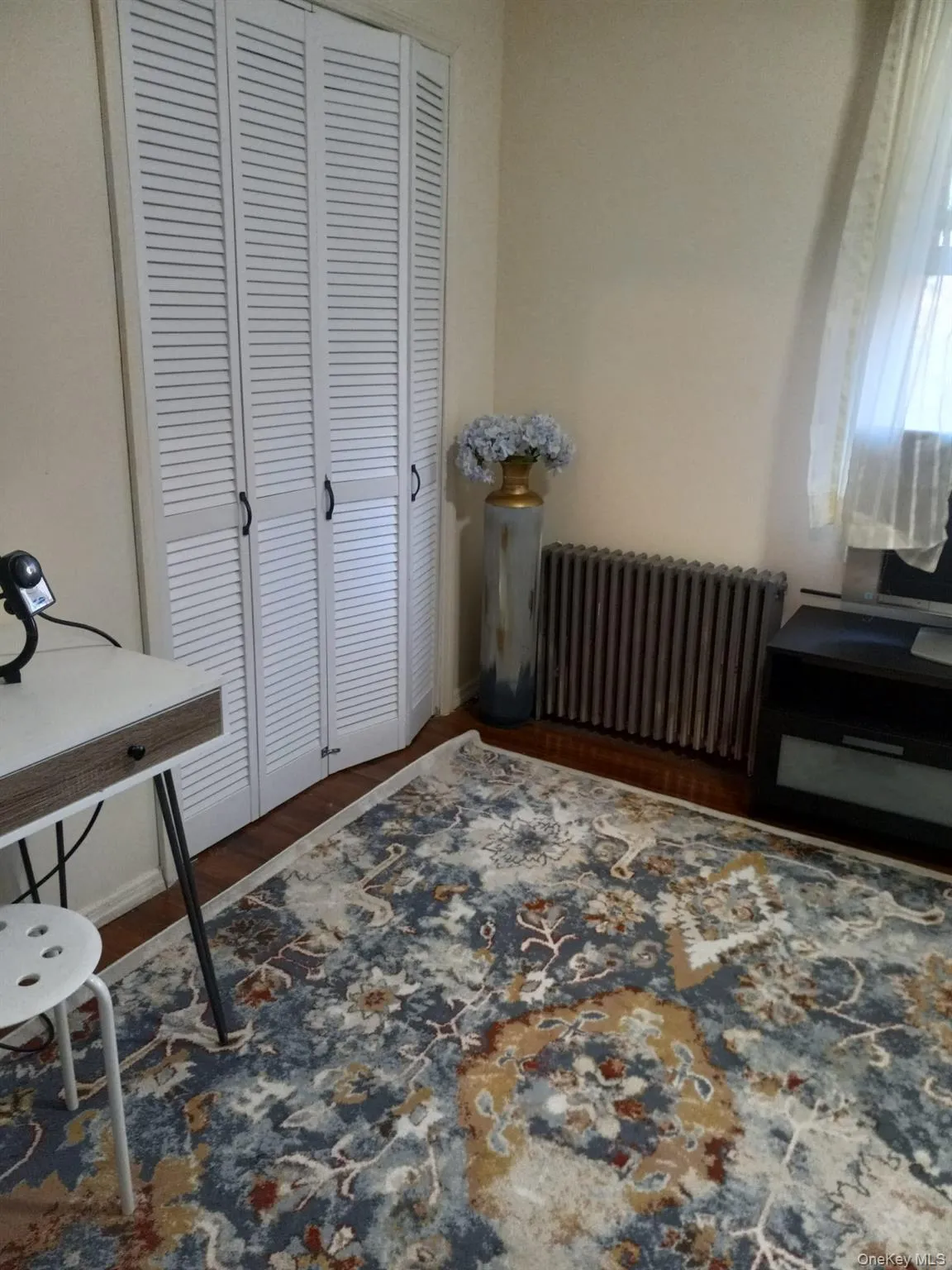 Home office with radiator heating unit and wood finished floors Home office with radiator heating unit and wood finished floors