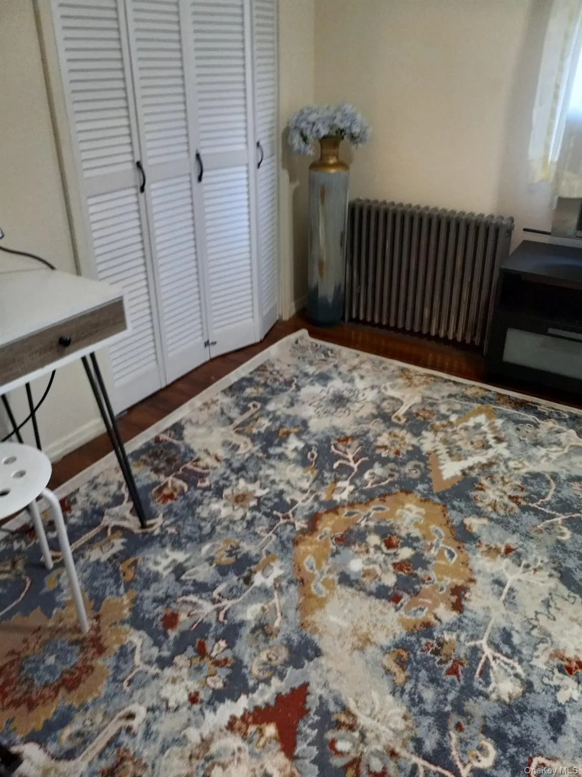 Office with radiator and wood finished floors Office with radiator and wood finished floors