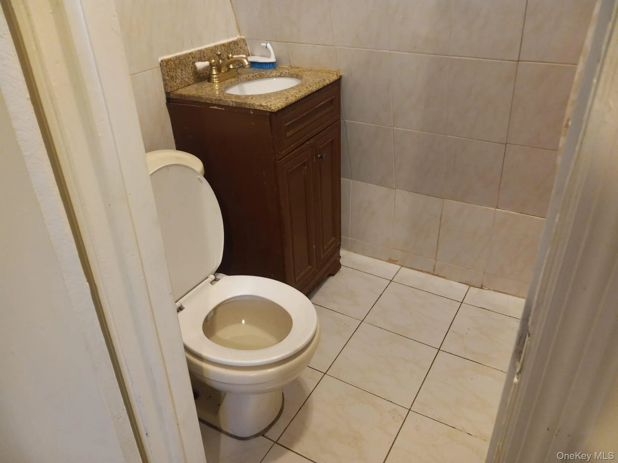 Bathroom with tile patterned flooring and vanity Bathroom with tile patterned flooring and vanity