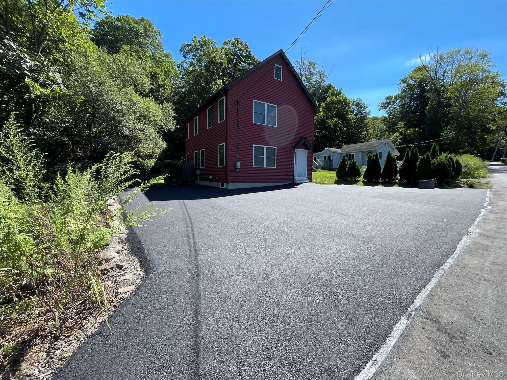 View of side of home featuring driveway View of side of home featuring driveway