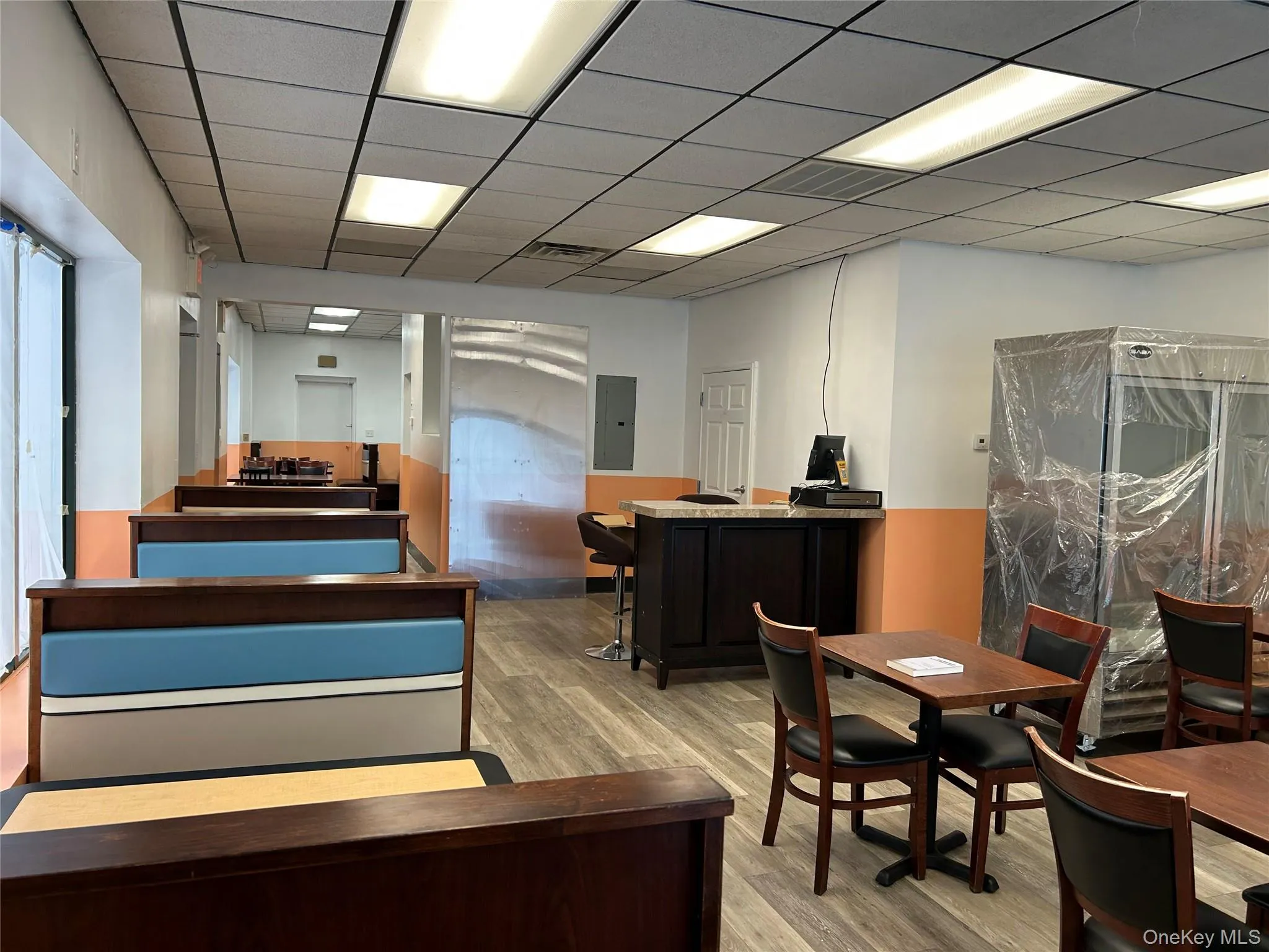 Office featuring electric panel and wood finished floors Office featuring electric panel and wood finished floors