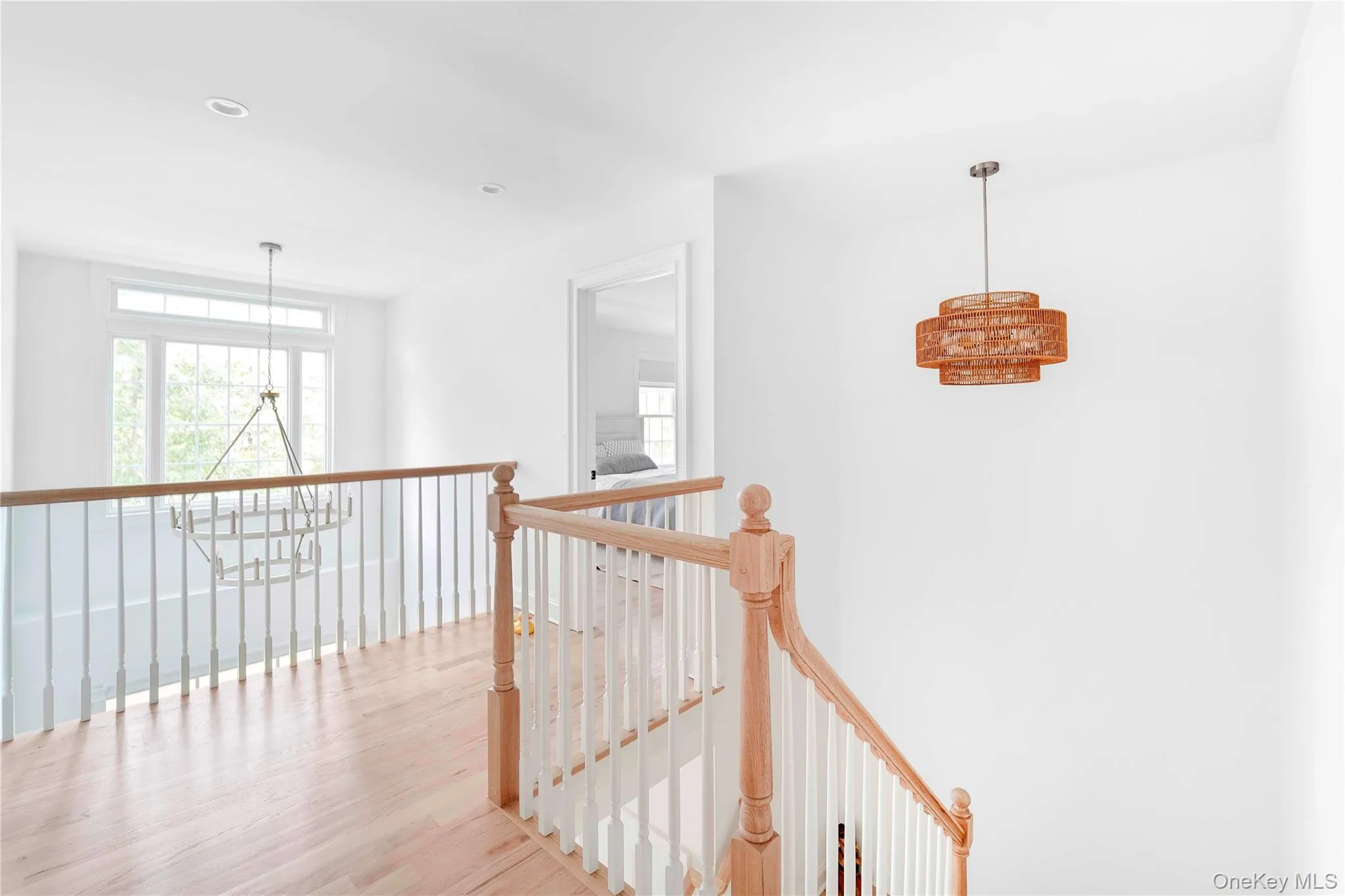 Corridor with an upstairs landing, light wood-style floors, and recessed lighting Corridor with an upstairs landing, light wood-style floors, and recessed lighting