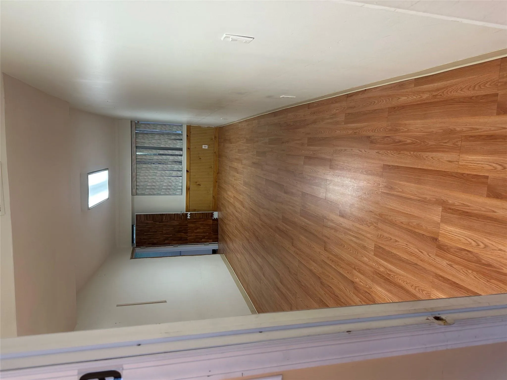 Unfurnished room with light wood-style floors and baseboards Unfurnished room with light wood-style floors and baseboards