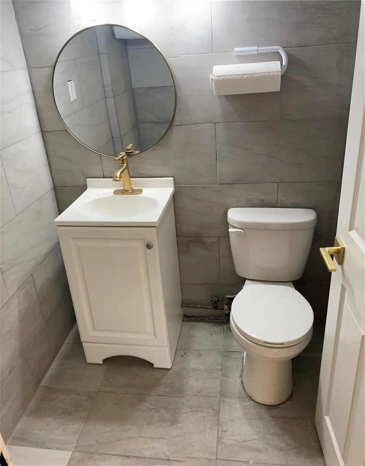Half bathroom featuring tile walls and vanity Half bathroom featuring tile walls and vanity
