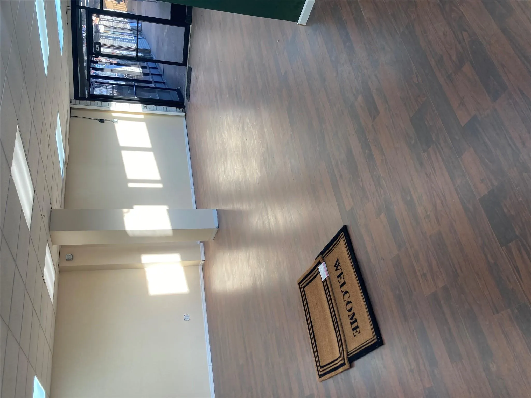 Empty room with wood finished floors and a paneled ceiling Empty room with wood finished floors and a paneled ceiling