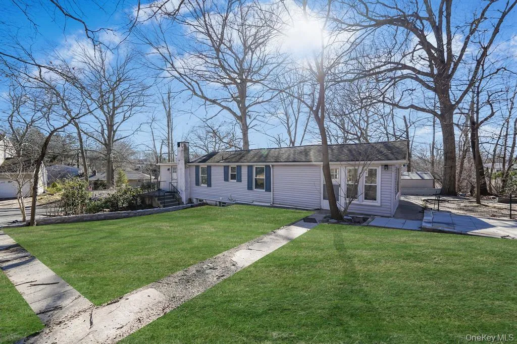 View of front of house featuring a chimney and a front lawn View of front of house featuring a chimney and a front lawn