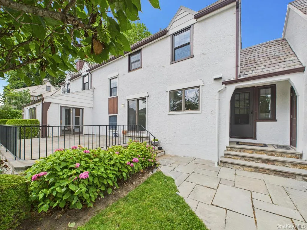 View of front facade featuring entry steps, stucco siding, and a high end roof View of front facade featuring entry steps, stucco siding, and a high end roof