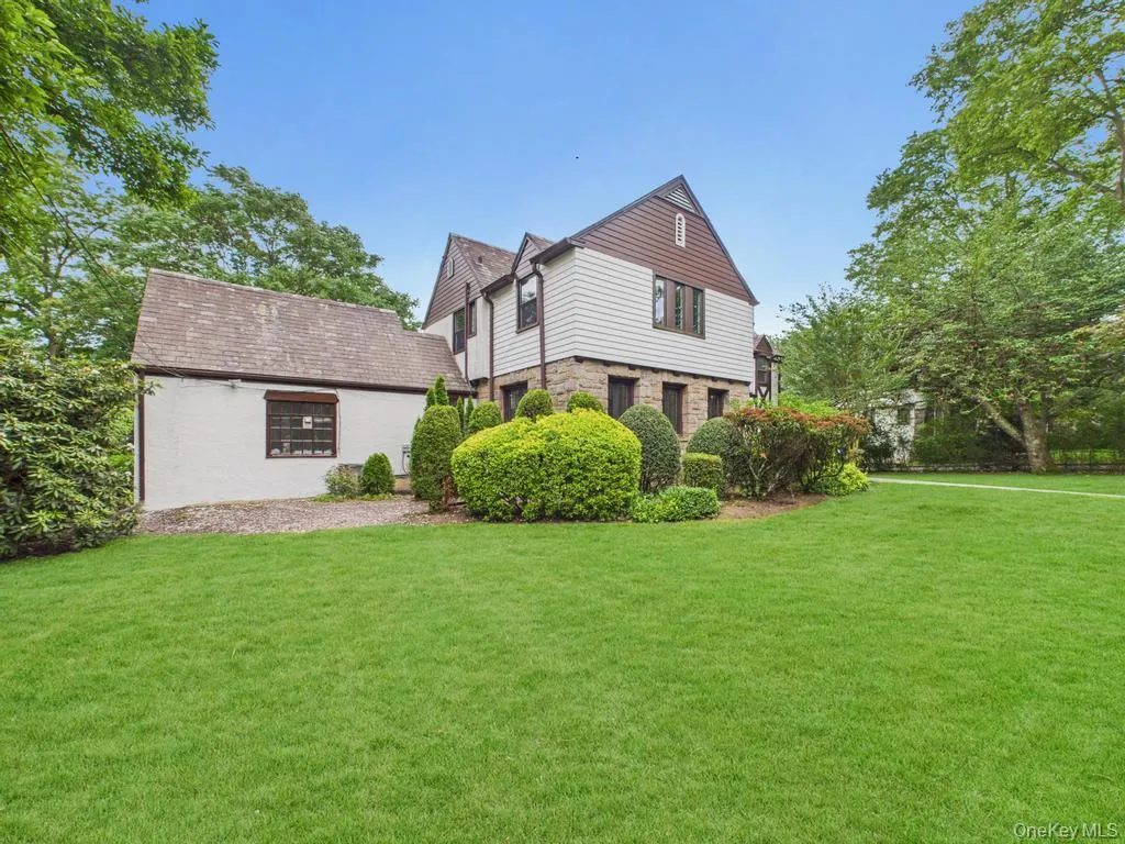 View of side of property featuring a lawn View of side of property featuring a lawn