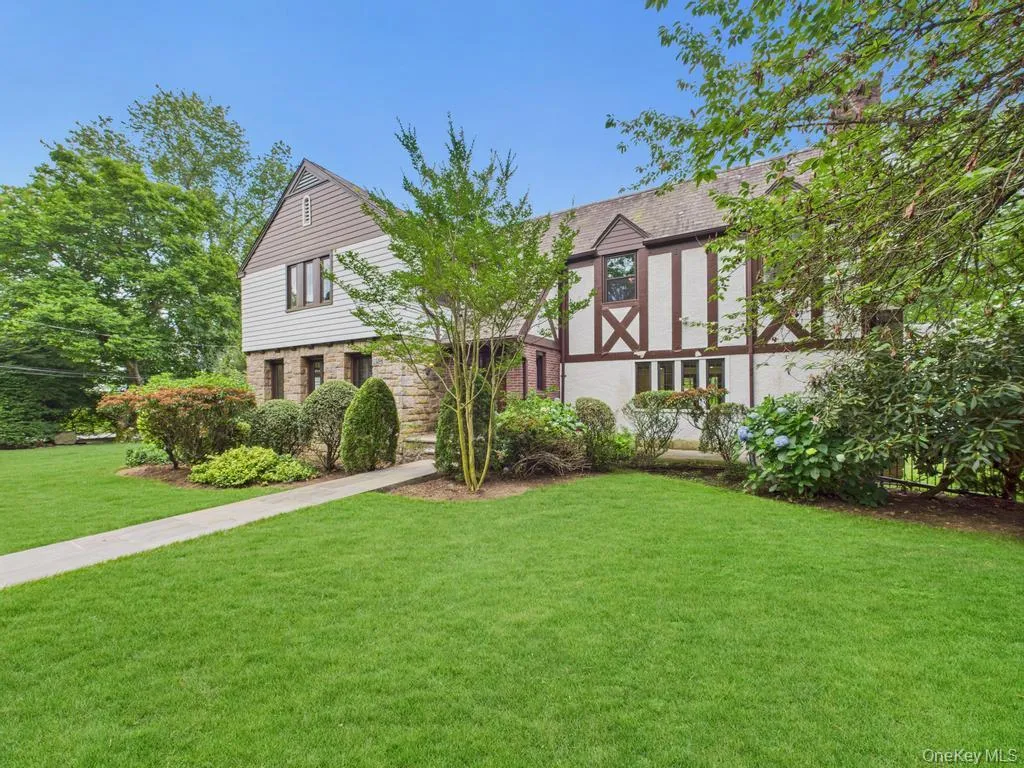 Tudor home with a front yard Tudor home with a front yard
