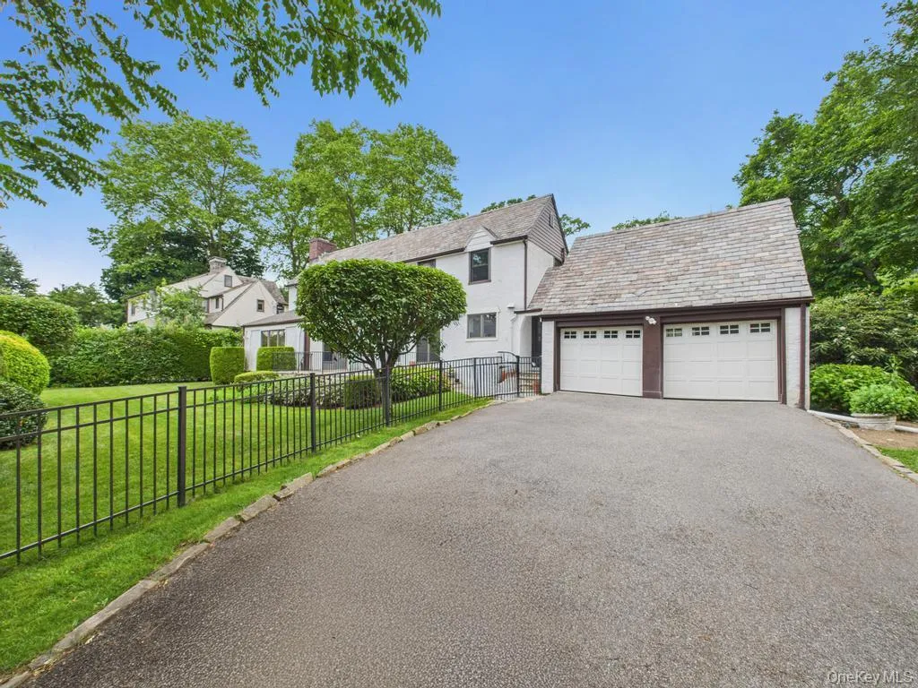 View of front of home with a high end roof and asphalt driveway View of front of home with a high end roof and asphalt driveway