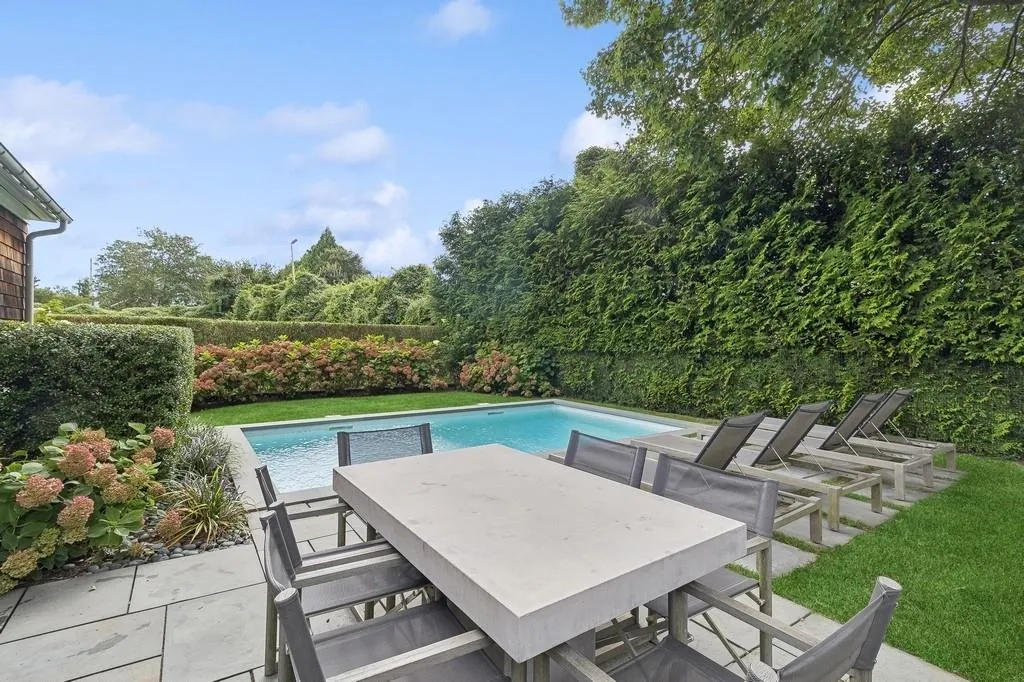 View of swimming pool featuring a fenced backyard, outdoor dining area, and a patio area View of swimming pool featuring a fenced backyard, outdoor dining area, and a patio area