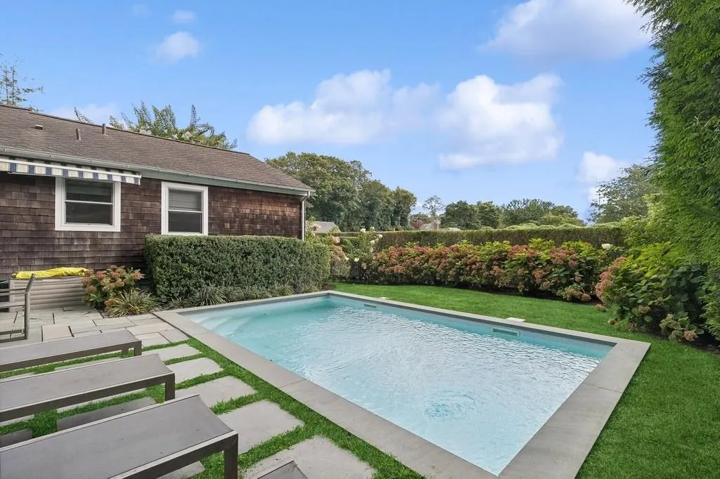 View of swimming pool featuring a yard View of swimming pool featuring a yard