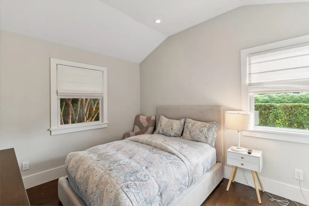 Bedroom with lofted ceiling, dark wood-style flooring, and recessed lighting Bedroom with lofted ceiling, dark wood-style flooring, and recessed lighting