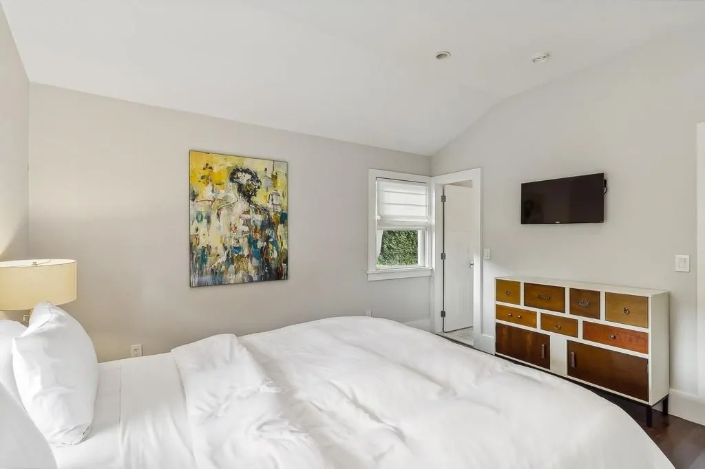 Bedroom with lofted ceiling and wood finished floors Bedroom with lofted ceiling and wood finished floors