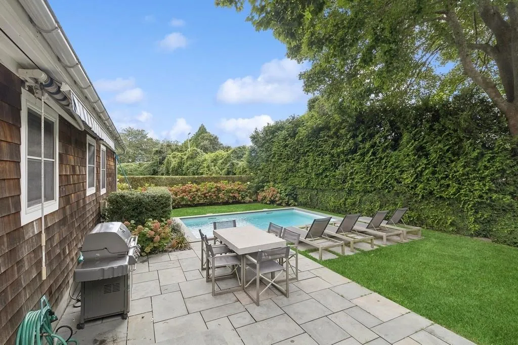 Fenced backyard featuring grilling area and a patio Fenced backyard featuring grilling area and a patio