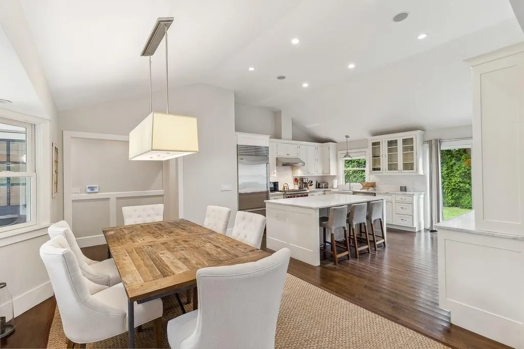 Dining space with vaulted ceiling, dark wood finished floors, and recessed lighting Dining space with vaulted ceiling, dark wood finished floors, and recessed lighting