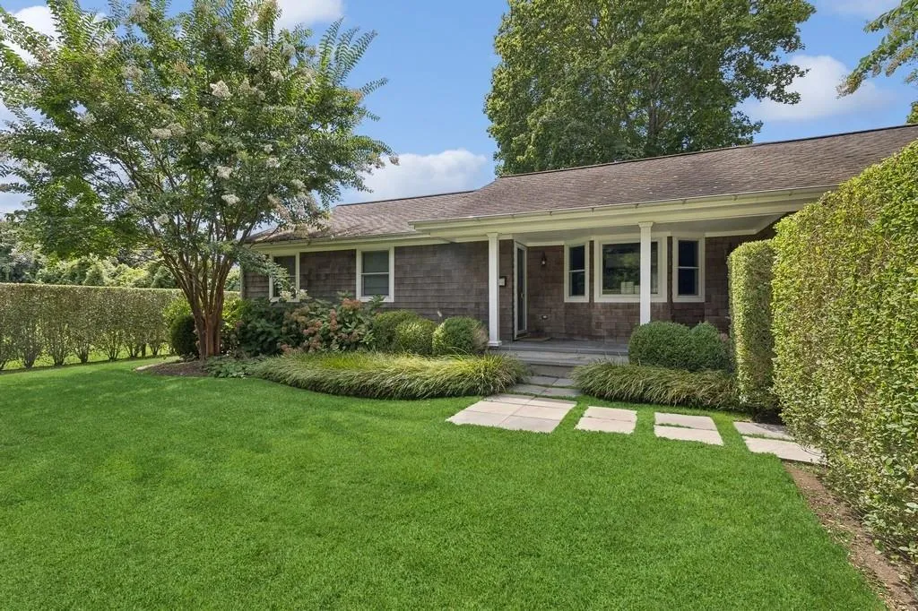 Ranch-style house featuring covered porch, a front yard, and a shingled roof Ranch-style house featuring covered porch, a front yard, and a shingled roof