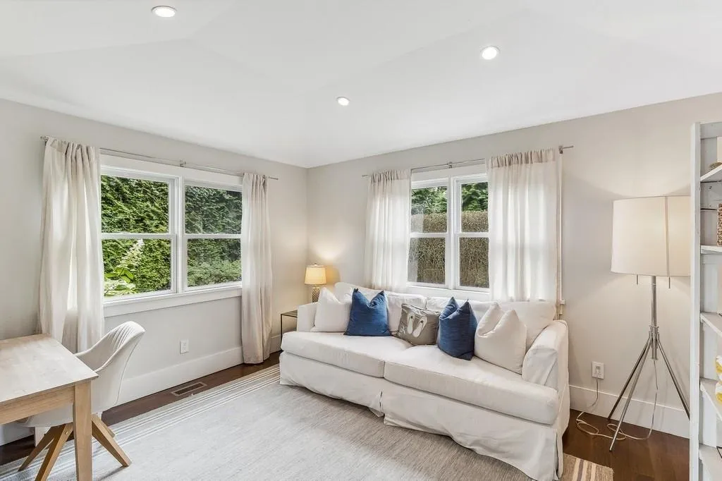 Living area with vaulted ceiling, wood finished floors, and recessed lighting Living area with vaulted ceiling, wood finished floors, and recessed lighting