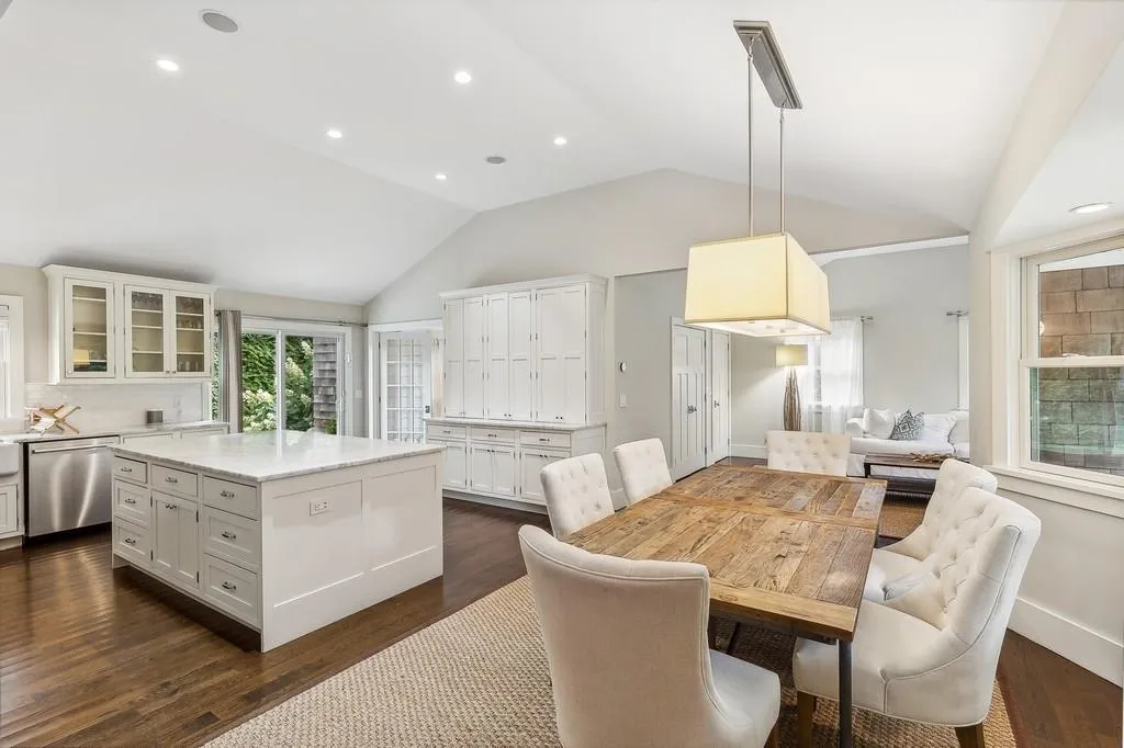 Dining space with vaulted ceiling, dark wood-style flooring, and recessed lighting Dining space with vaulted ceiling, dark wood-style flooring, and recessed lighting