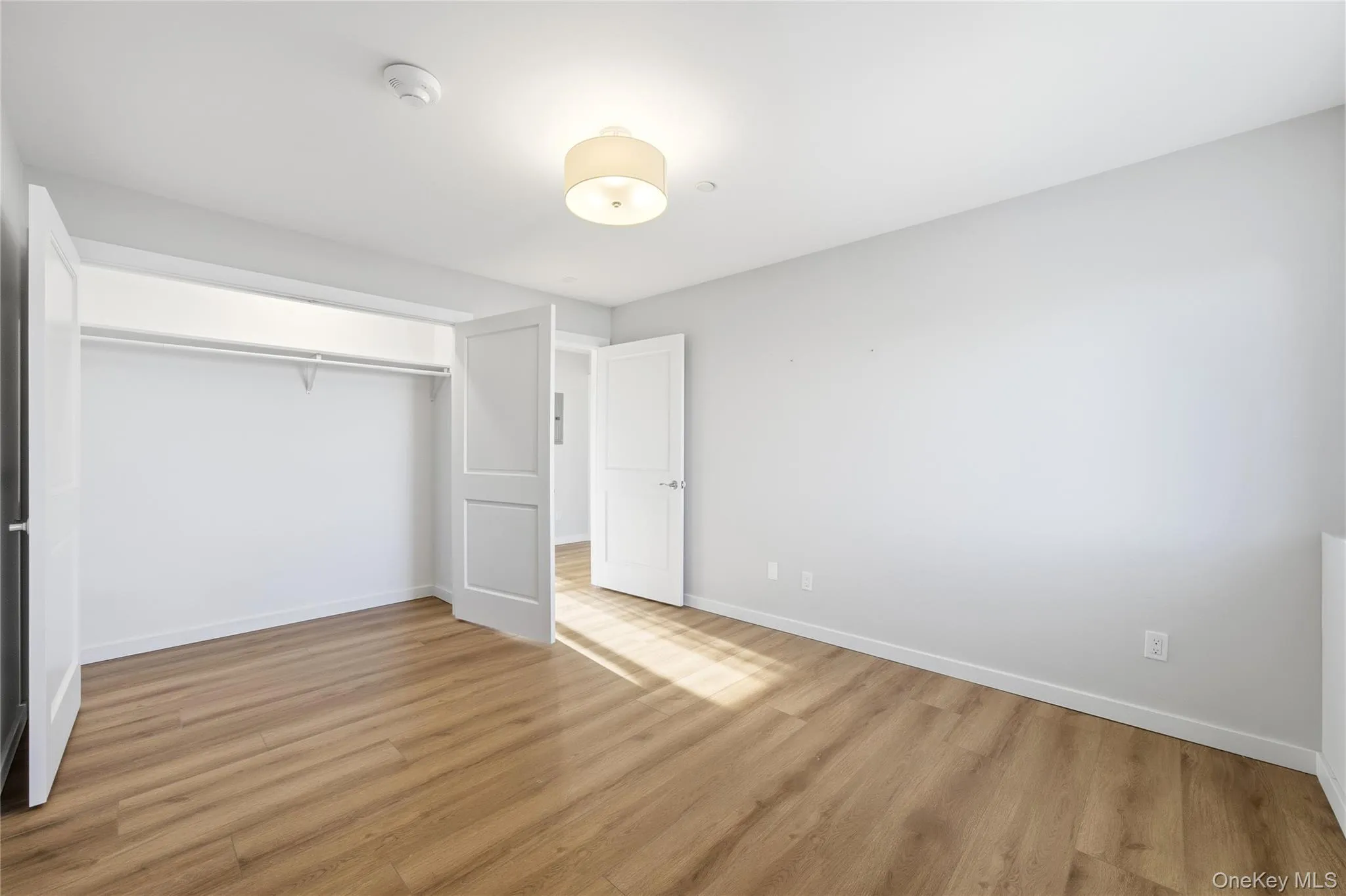 Second bedroom with view of closet and light wood-style floors Second bedroom with view of closet and light wood-style floors