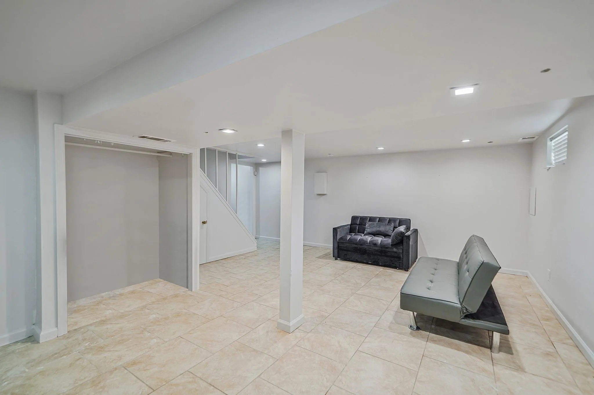 Basement featuring recessed lighting and stairway Basement featuring recessed lighting and stairway