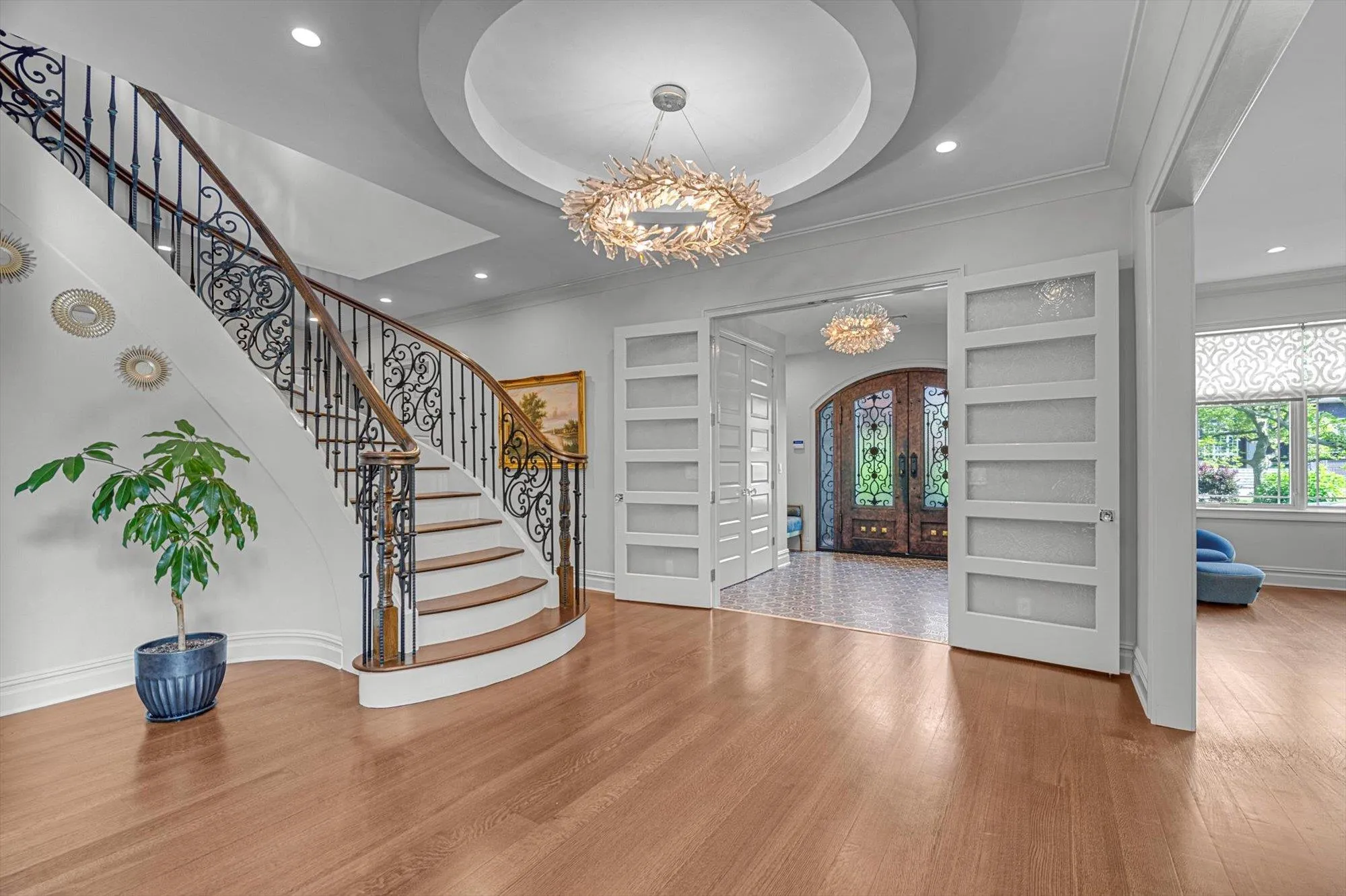 Foyer featuring a chandelier, wood finished floors, stairway, crown molding, and recessed lighting Foyer featuring a chandelier, wood finished floors, stairway, crown molding, and recessed lighting