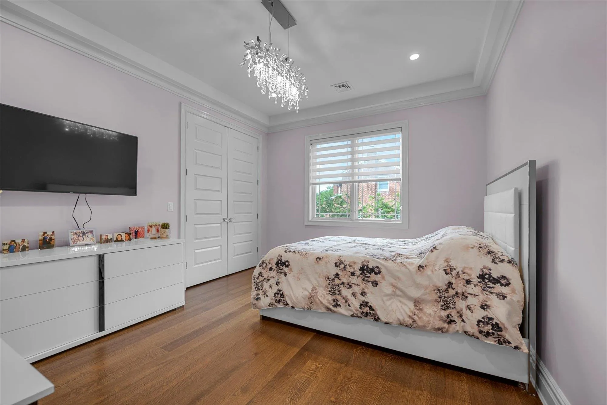 Bedroom featuring wood finished floors, a closet, ornamental molding, a chandelier, and recessed lighting Bedroom featuring wood finished floors, a closet, ornamental molding, a chandelier, and recessed lighting