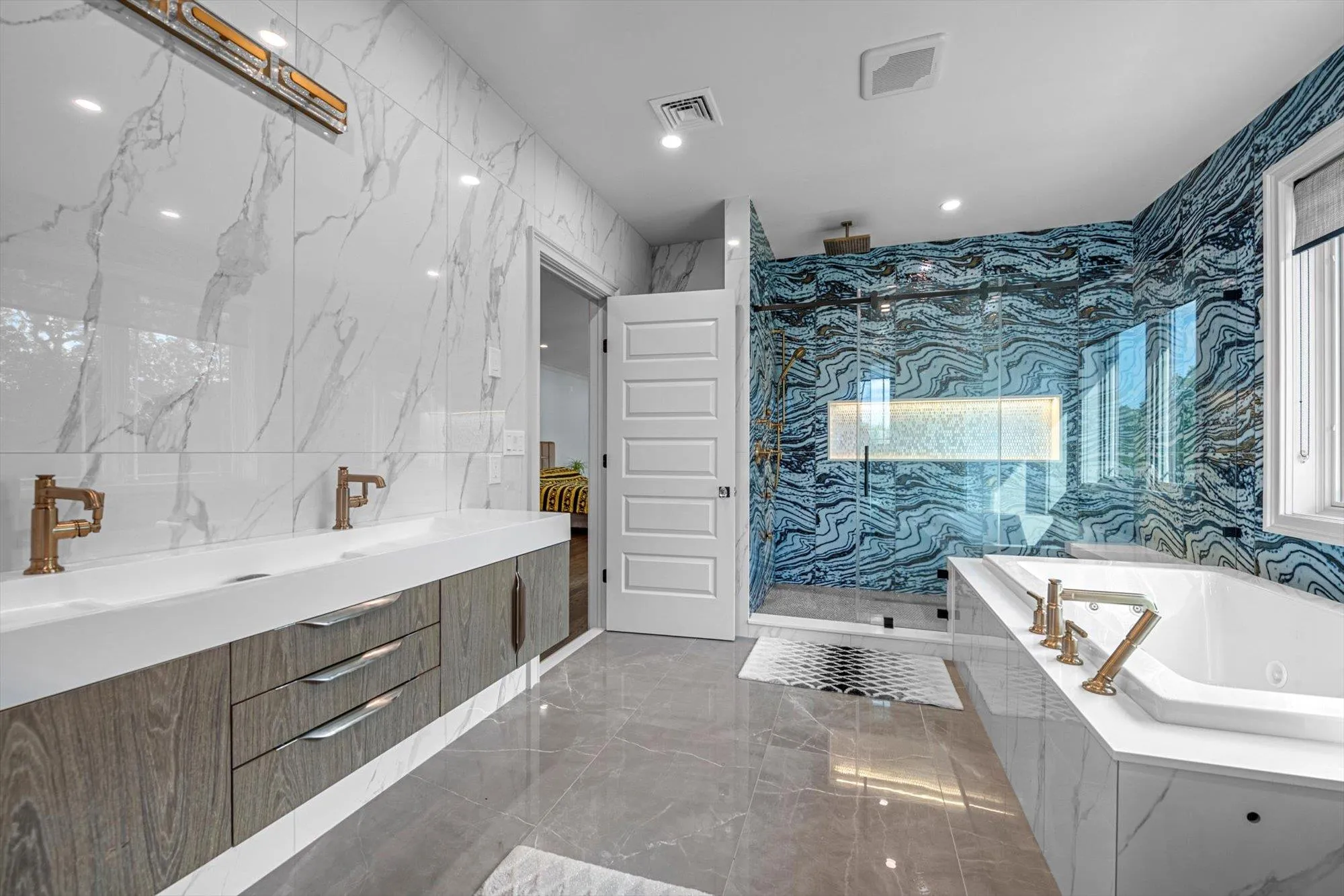 Primary Spa Bathroom with marble tiled flooring, a marble finish shower, a jetted tub, and recessed lighting Primary Spa Bathroom with marble tiled flooring, a marble finish shower, a jetted tub, and recessed lighting