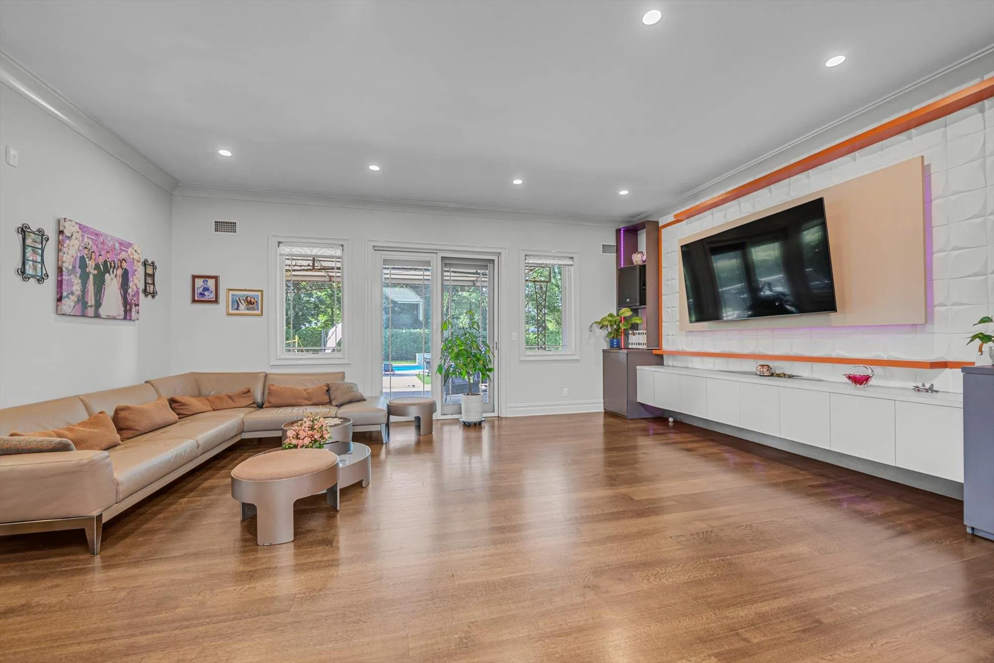 Family room featuring Built in Entertainment Center, ornamental molding, light wood finished floors, and recessed lighting Family room featuring Built in Entertainment Center, ornamental molding, light wood finished floors, and recessed lighting