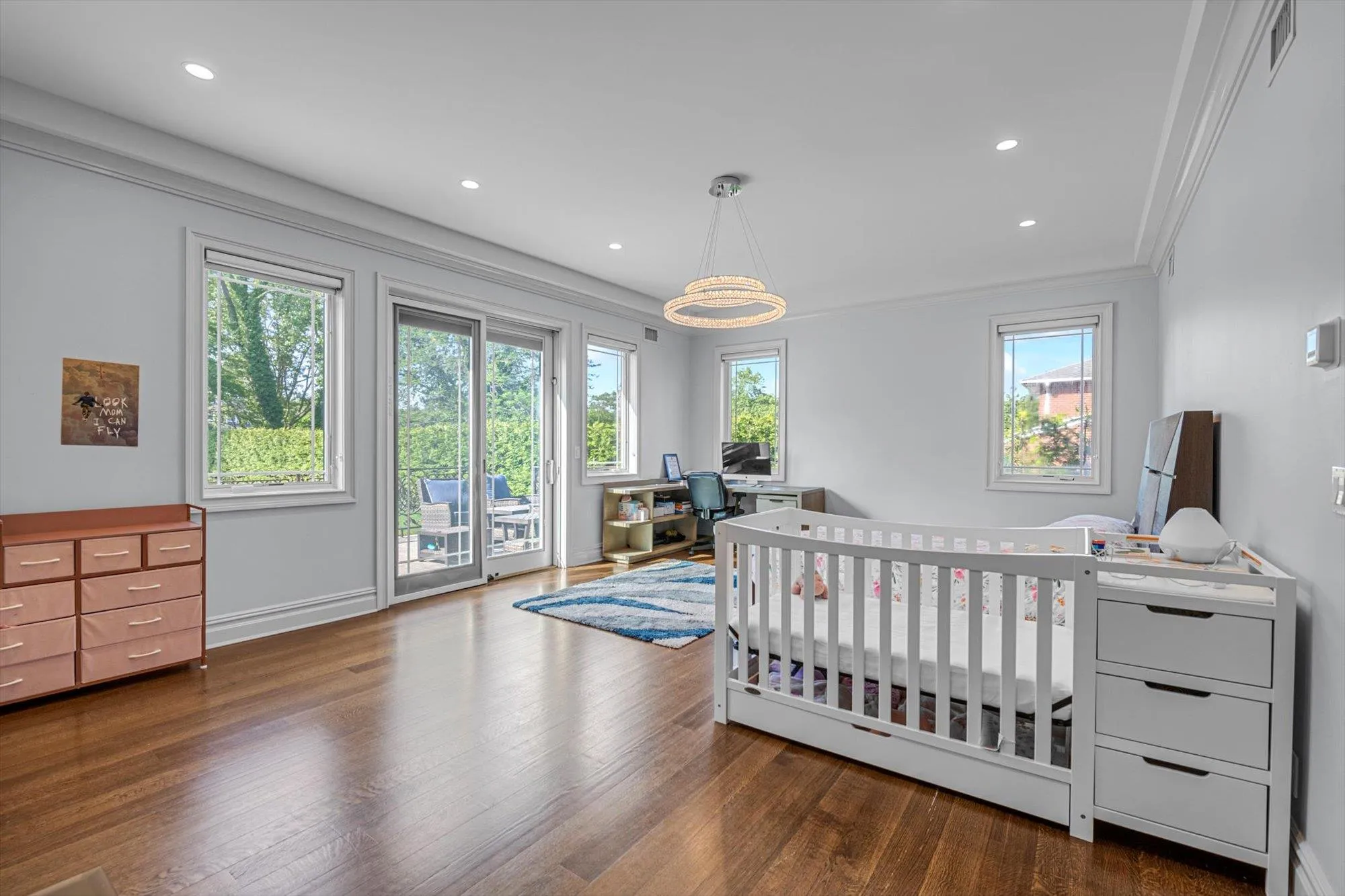 Main Floor Primary Bedroom with Ensuite Bath, wood finished floors, Custom Walk in Closet, crown molding, recessed lighting, and access to outside Main Floor Primary Bedroom with Ensuite Bath, wood finished floors, Custom Walk in Closet, crown molding, recessed lighting, and access to outside