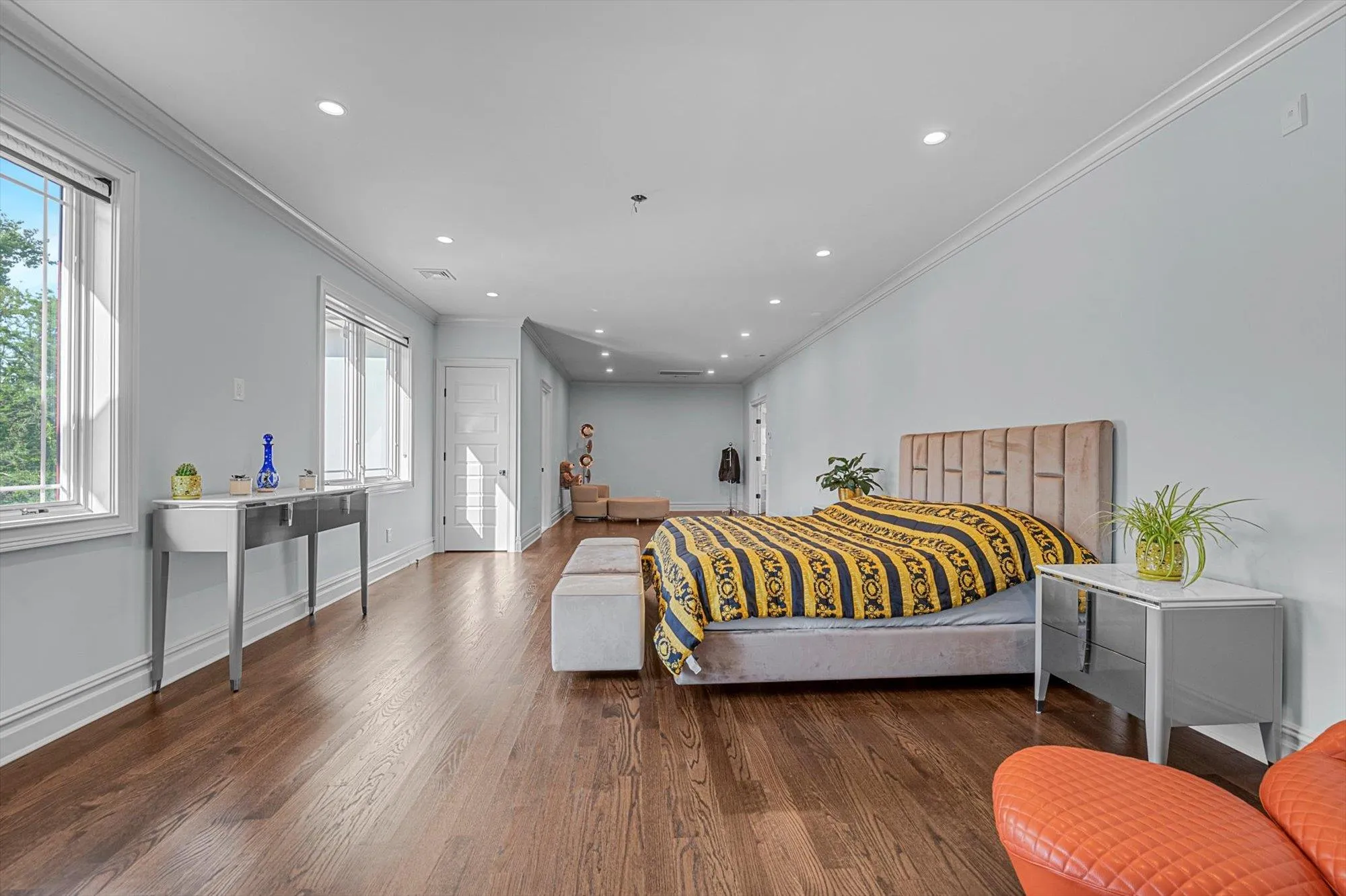 Second Floor Primary Bedroom with Ensuite Spa Bathroom, ornamental molding, multiple windows, wood finished floors, and recessed lighting Second Floor Primary Bedroom with Ensuite Spa Bathroom, ornamental molding, multiple windows, wood finished floors, and recessed lighting